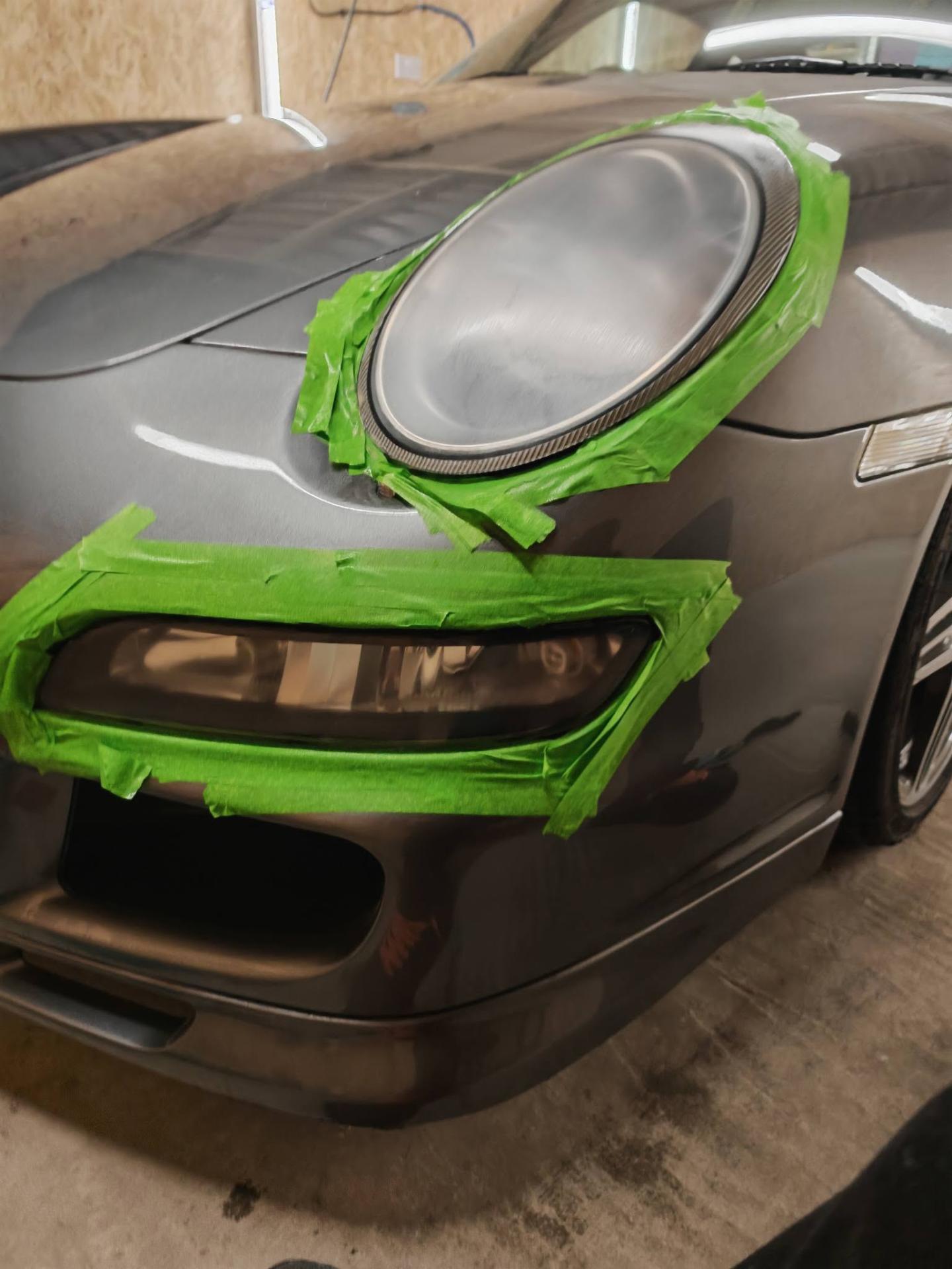 Porsche 911 headlight masked and prepared for headlight restoration
