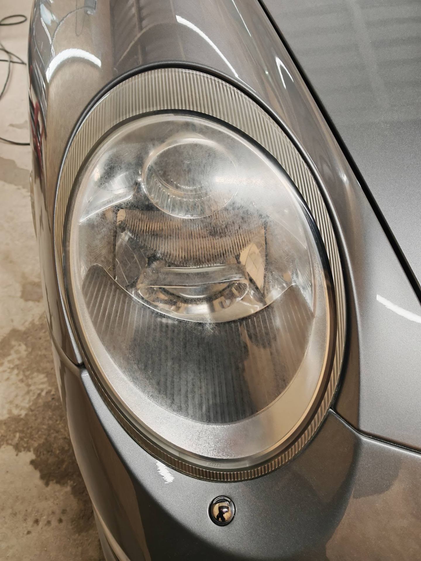Hazed, oxidised headlight before restoration at Tailored Detail