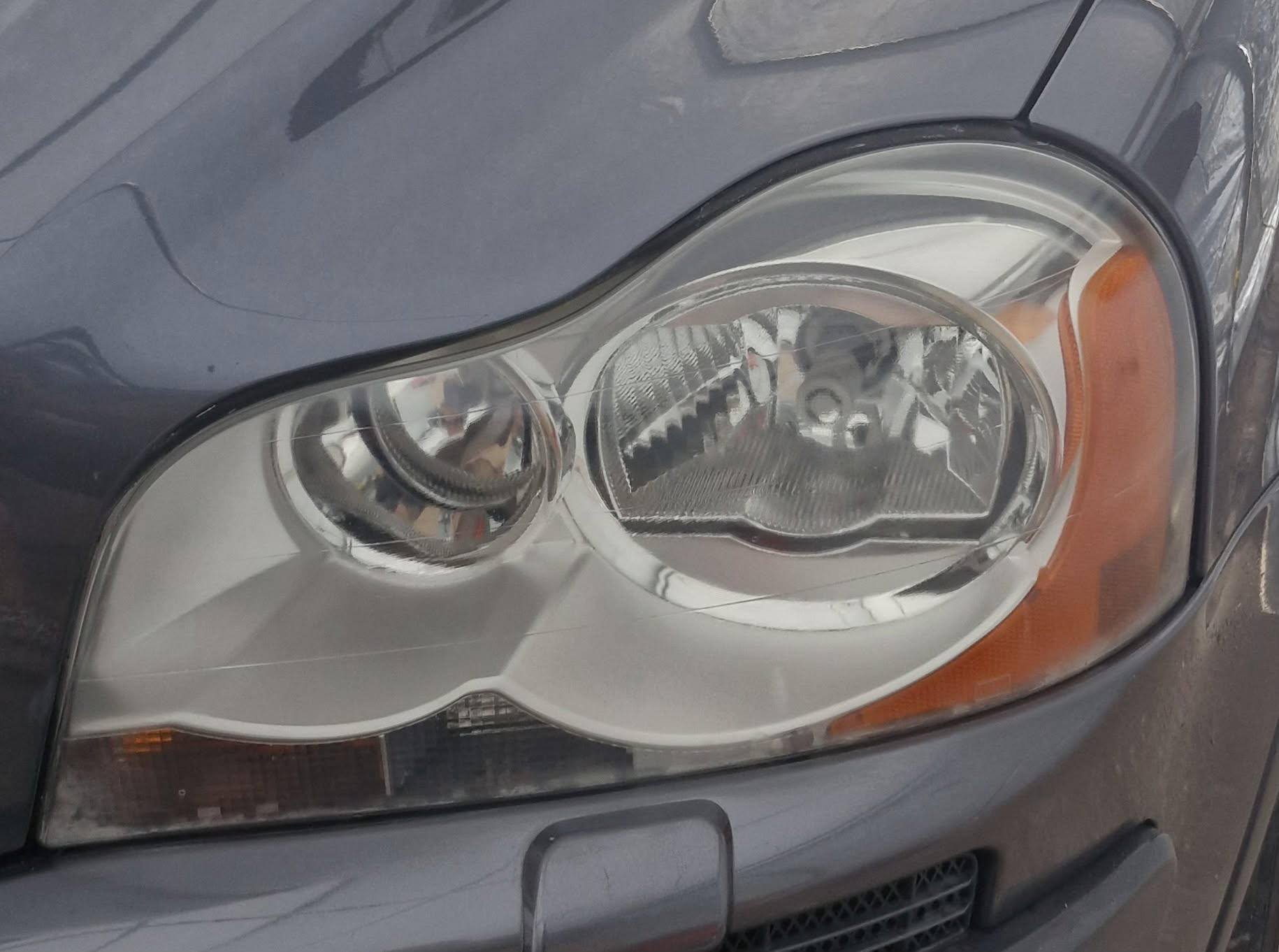 Crystal-clear restored headlight lens after multi-stage headlight restoration by Tailored Detail